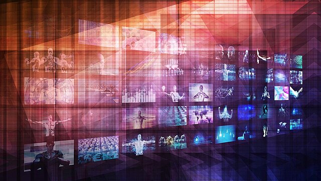 Abstrakcyjna grafika przedstawiająca szereg ekranów kompiterowych ułożonych w formie kafelków na ścianie